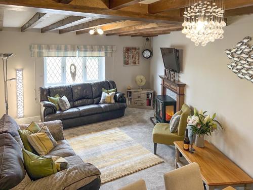 a living room with a couch and a table at Ash Cottage E1224 in Addlethorpe