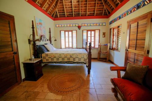 a bedroom with a bed and a couch in a room at Tingalaya's Retreat in Negril