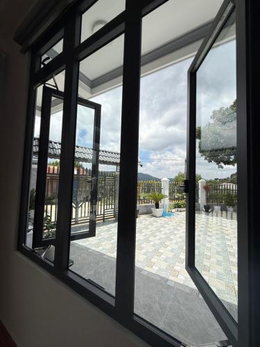 a window view of a patio from a house at Mây HomeStay in Da Lat