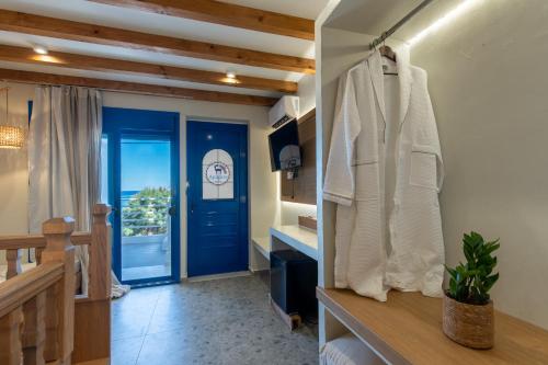 a bathroom with a blue door and a room at Apágkio Filoxenia in Archangelos