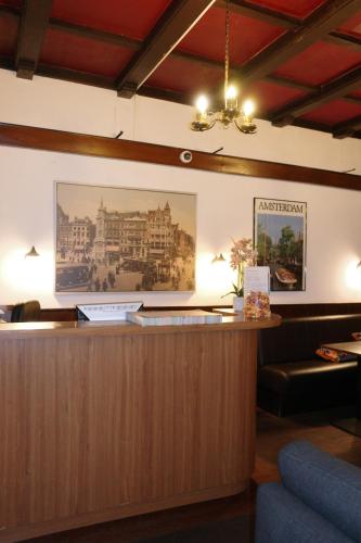 a reception desk with a picture of a building at Hotel Sphinx in Amsterdam