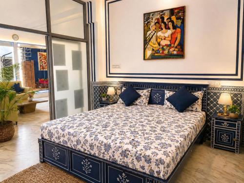 a bedroom with a bed with a painting on the wall at C44thelocalhistory in Jaipur
