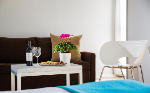 a living room with a couch and a table with a plate of food at Prima City Hotel in Tel Aviv