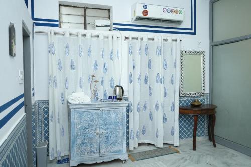 a room with a white curtain and a table at C44thelocalhistory in Jaipur