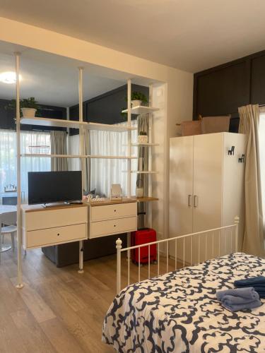 a bedroom with a bed and a desk with a computer at pinetadamare in Porto SantʼElpidio