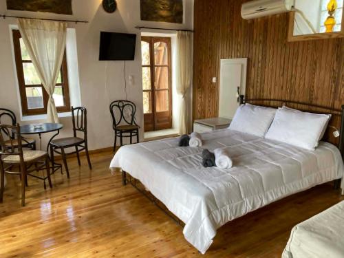a bedroom with a bed with a cat laying on it at Melinda Tower in Plomari