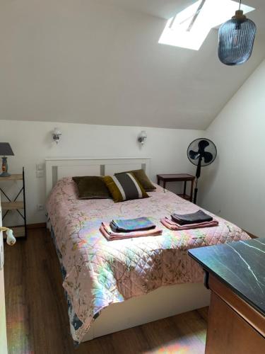 a bedroom with a bed with blankets and pillows on it at Coco Bonnevie in Murat
