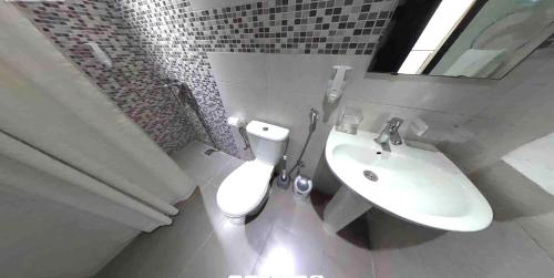 a bathroom with a toilet and a sink at ALYA SAPHIR in Saïdia