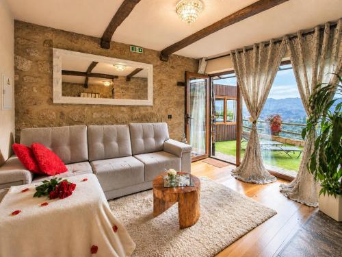 a living room with a couch and a table at Casa Love Story - Piscina, Sauna & Jacuzzi in Arcos de Valdevez