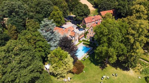 an aerial view of a house with a swimming pool at Landhaus Eggert in Münster