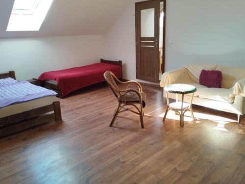 a living room with two chairs and a table at Krčma na statku in Zásmuky