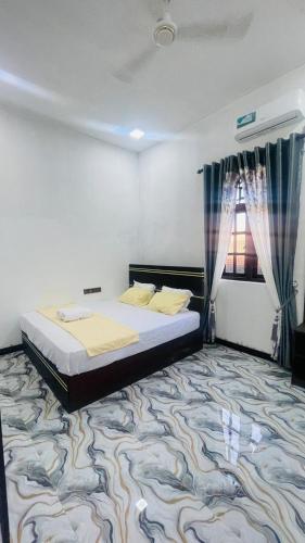 a bedroom with a bed and a large carpet at MOMS Villa in Arugam Bay