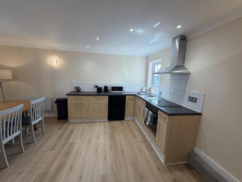 a kitchen with a stove and a counter top at Ely Stays City Center 2 Bedroom Flat in Ely