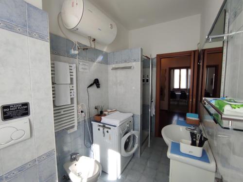 a small bathroom with a toilet and a sink at Margot's House Rho in Rho