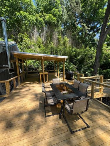 a patio with a table and chairs on a deck at Canvasback Cove on Caddo Lake in Jefferson
