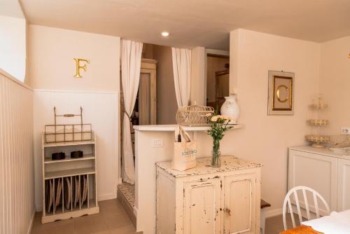 a room with a table with a vase of flowers on it at La Limonaia - Tremezzo by LoveComo in Tremezzo