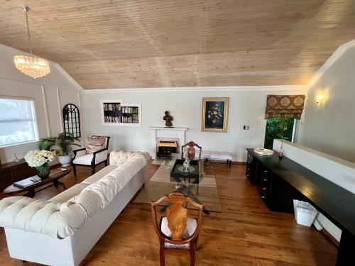 a living room with a white couch and a fireplace at Serenity Suite in Somerset West
