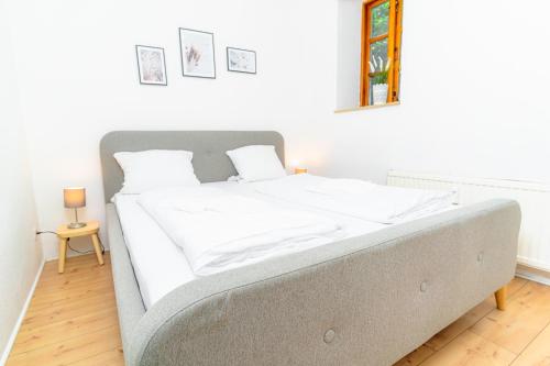 a bedroom with a large bed with white sheets at fewo1846 - Smutjes Koje - für eine entspannte Auszeit mit Balkon im Stadtzentrum in Flensburg