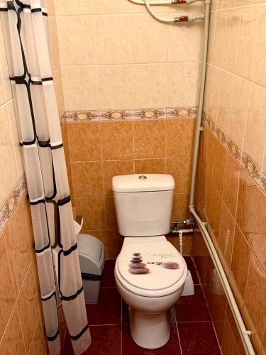 a bathroom with a toilet in a small room at RestMax in Nida