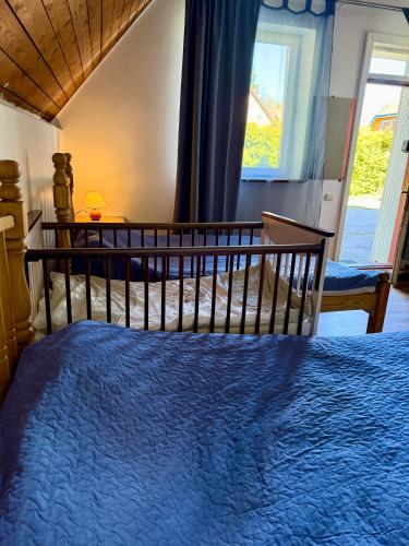 a bedroom with a large bed and a window at RestMax in Nida