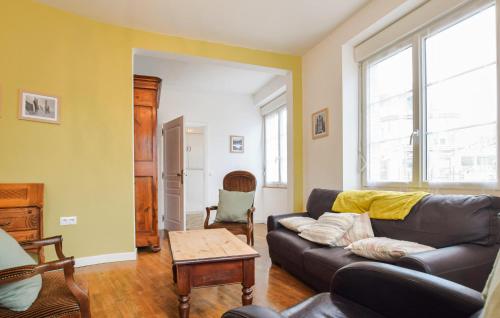 a living room with a couch and a table at Agréable Jardin Et Terrasse in Sourdeval