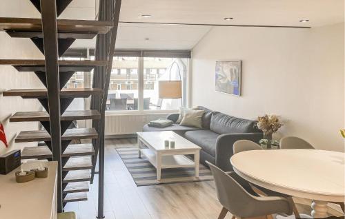 a living room with a couch and a table at Awesome Apartment In Faaborg With Sauna in Faaborg
