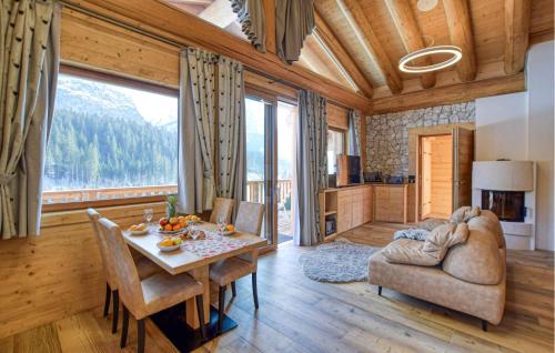 a living room with a table and a couch at Gorgeous Home In Sappada With Sauna in Sappada