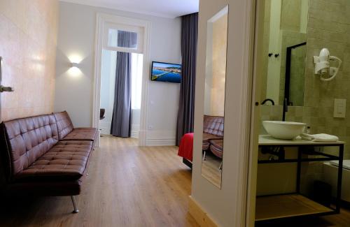 a living room with a couch and a shower at Republica Vintage House in Viana do Castelo