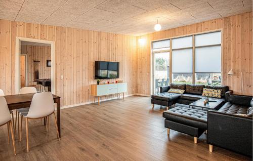 a living room with a couch and a table at Gorgeous Home In Grenaa With Sauna in Grenå