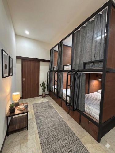 a large room with three bunk beds in it at Base Seven Hostel in Bandung