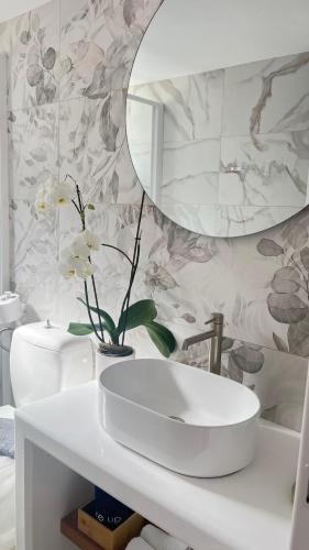 a bathroom with a white sink and a mirror at VERADA HOUSE in Pera Gyalos