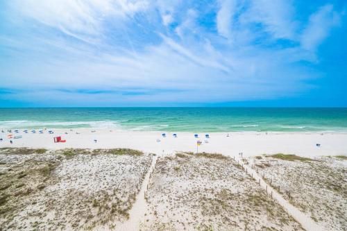 a group of people on a beach with the ocean at Driftwood Towers 6D condo in Gulf Shores
