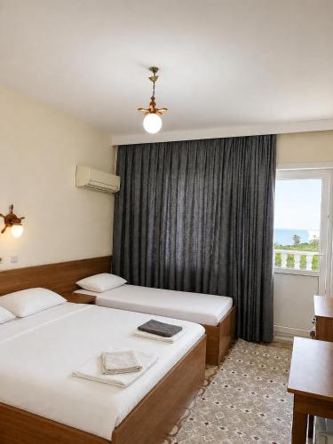 a hotel room with two beds and a window at Hotel Schönberg in Kızılot