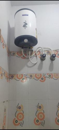 a hair dryer sitting on the wall of a bathroom at HOTEL SEA ROCk in Belagula