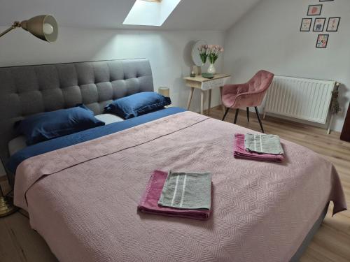 a bedroom with a large bed with two towels on it at Fay-home in Odorheiu Secuiesc