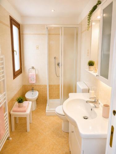 a bathroom with a sink and a toilet and a shower at President Frontemare - Agenzia Cocal in Caorle