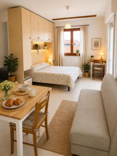 a living room with two beds and a table with a tableasteryasteryasteryastery at President Frontemare - Agenzia Cocal in Caorle