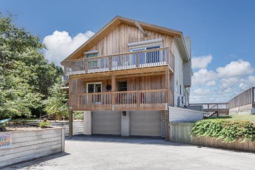 a wooden house with a balcony on top of it at 7815 - Tarhoo in Frisco
