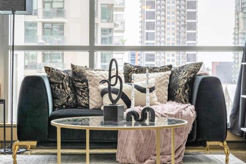 a living room with a couch and a table at Jungle Book Luxe Suite Downtown BMO in Calgary