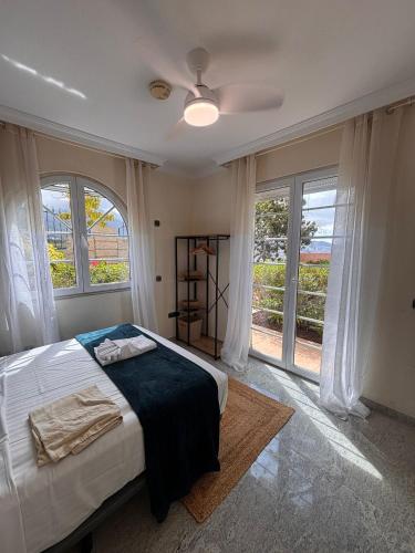 a bedroom with a bed and a large window at Gorgeous Golf Villa Heated Pool Sea view in Adeje