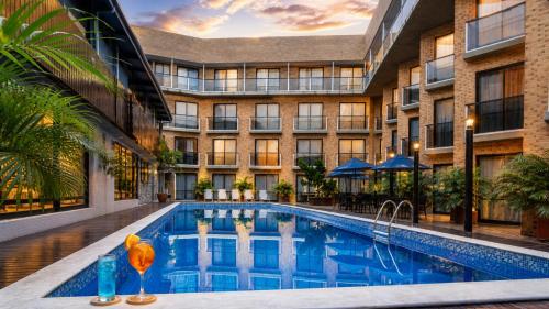 a large building with a pool in front of a building at Bessa Beach Hotel in João Pessoa