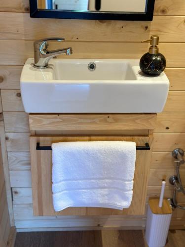 a bathroom with a sink and a white towel at Sarajevo jacuzzi sauna Forest romance lodge in Sarajevo