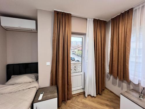 a bedroom with a bed and a window at BS Brother in Ruse