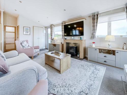a living room with a couch and a table at Turnberry Lodge in Girvan