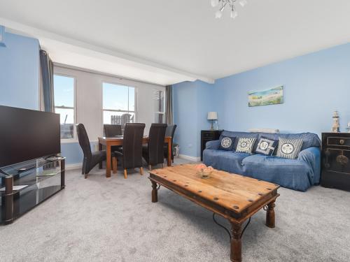 a living room with a couch and a table at The Garden Apartment in Peel