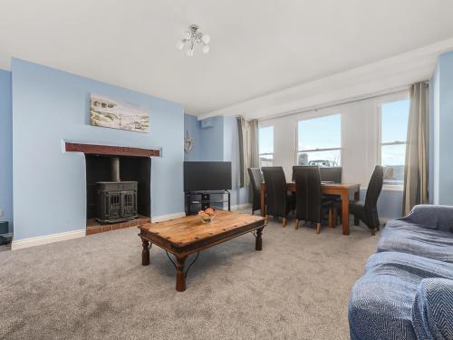 a living room with a couch and a table at The Garden Apartment in Peel