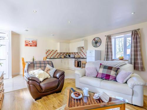 a living room with a couch and a table at Cut Lloi in Llanfair Caereinion