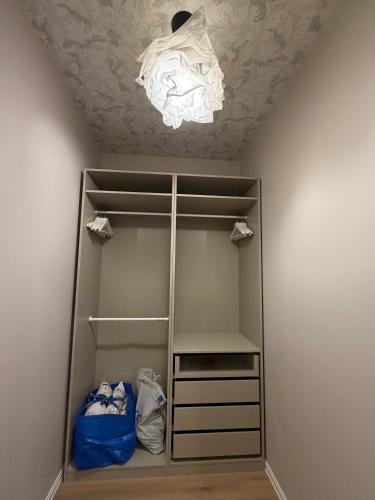 a walk in closet with a light hanging from a ceiling at Luxe Lumine Apartment #2 in Kohtla-Järve