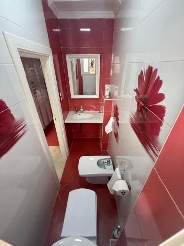 a bathroom with a white toilet and a sink at Pavillon corniche Bord de mer Proche Centre in Mohammedia