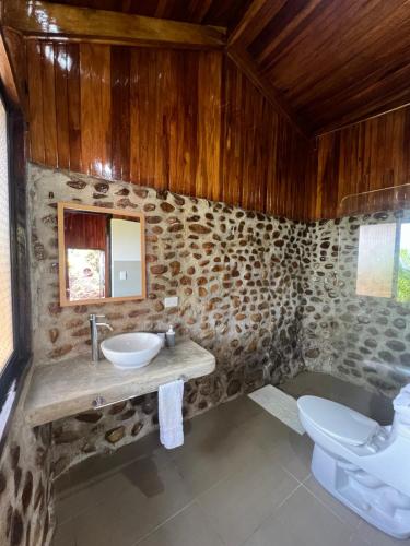 a bathroom with a sink and a toilet at Hotel El Jardin in Montezuma